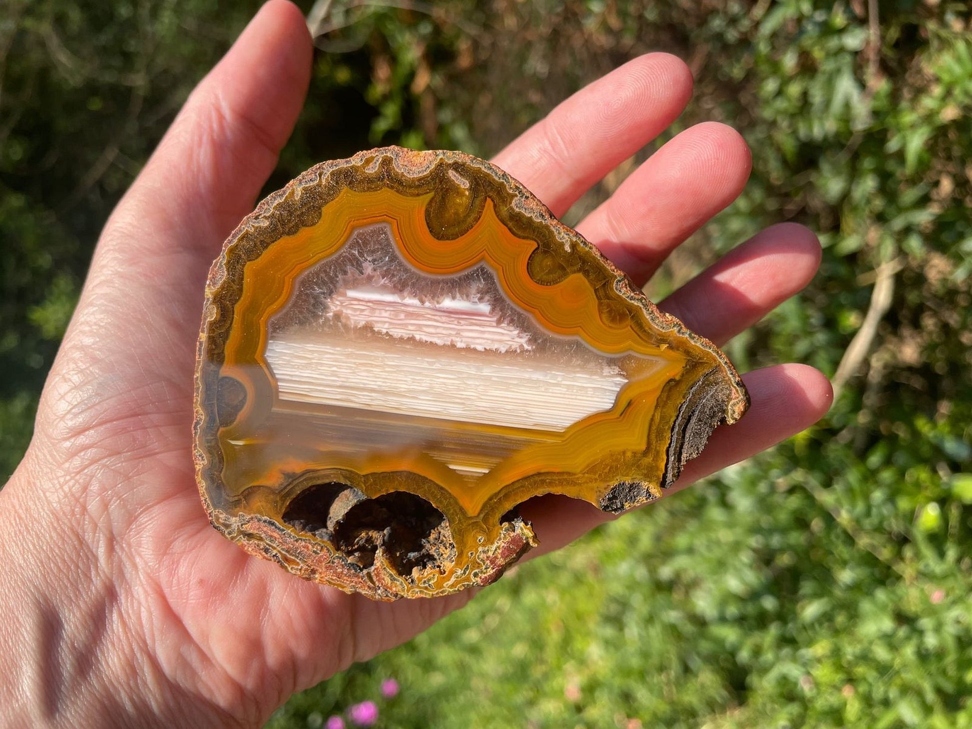 Lilangabi agate 87 mm – in-hand size reference, fortification banding and waterline features visible, Eswatini | SKU LIL00004