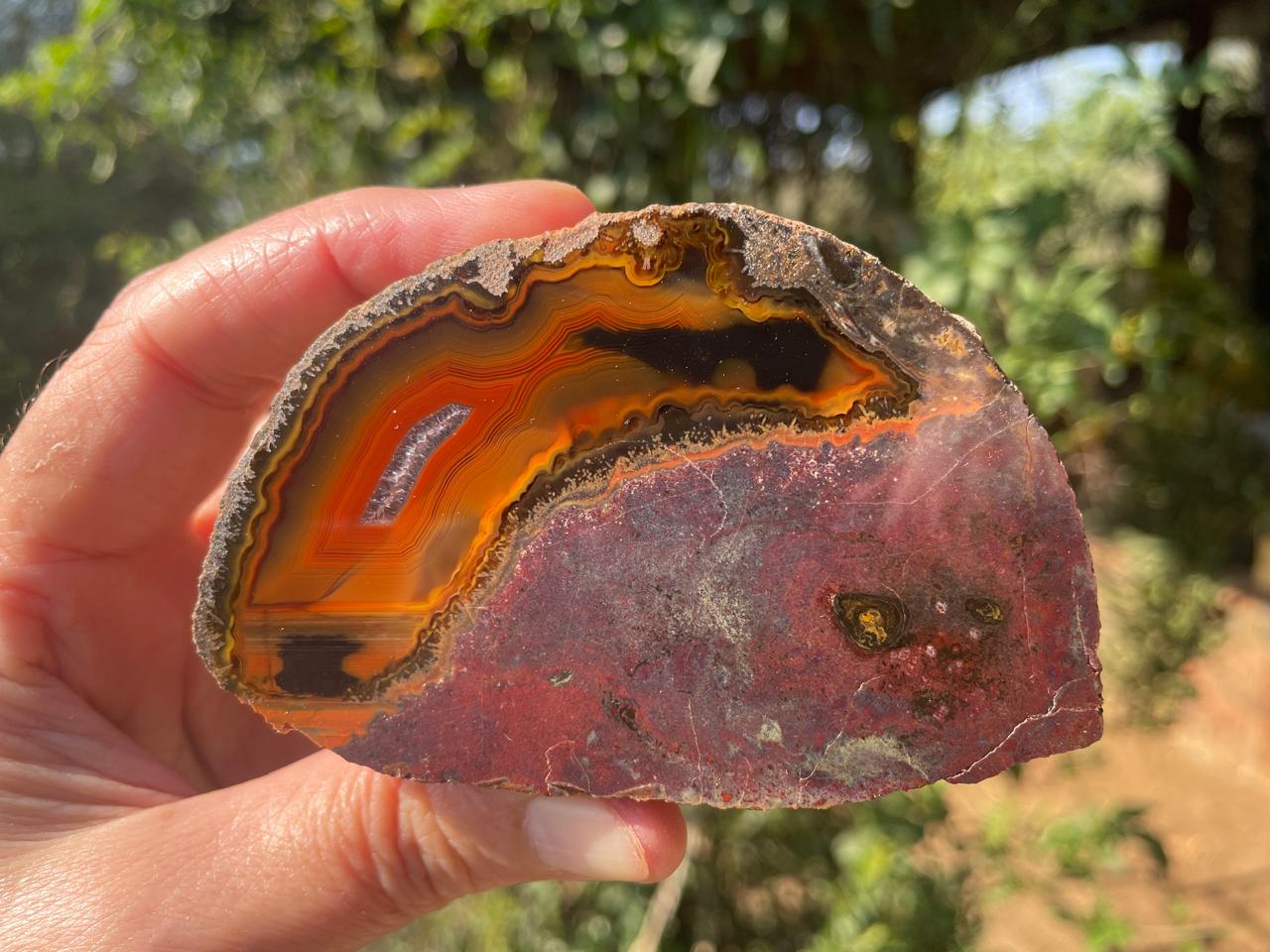 Lilangabi agate 87 mm – in-hand view, chromatism, waterlines, vivid orange-red and black palette, Eswatini | SKU LIL00032