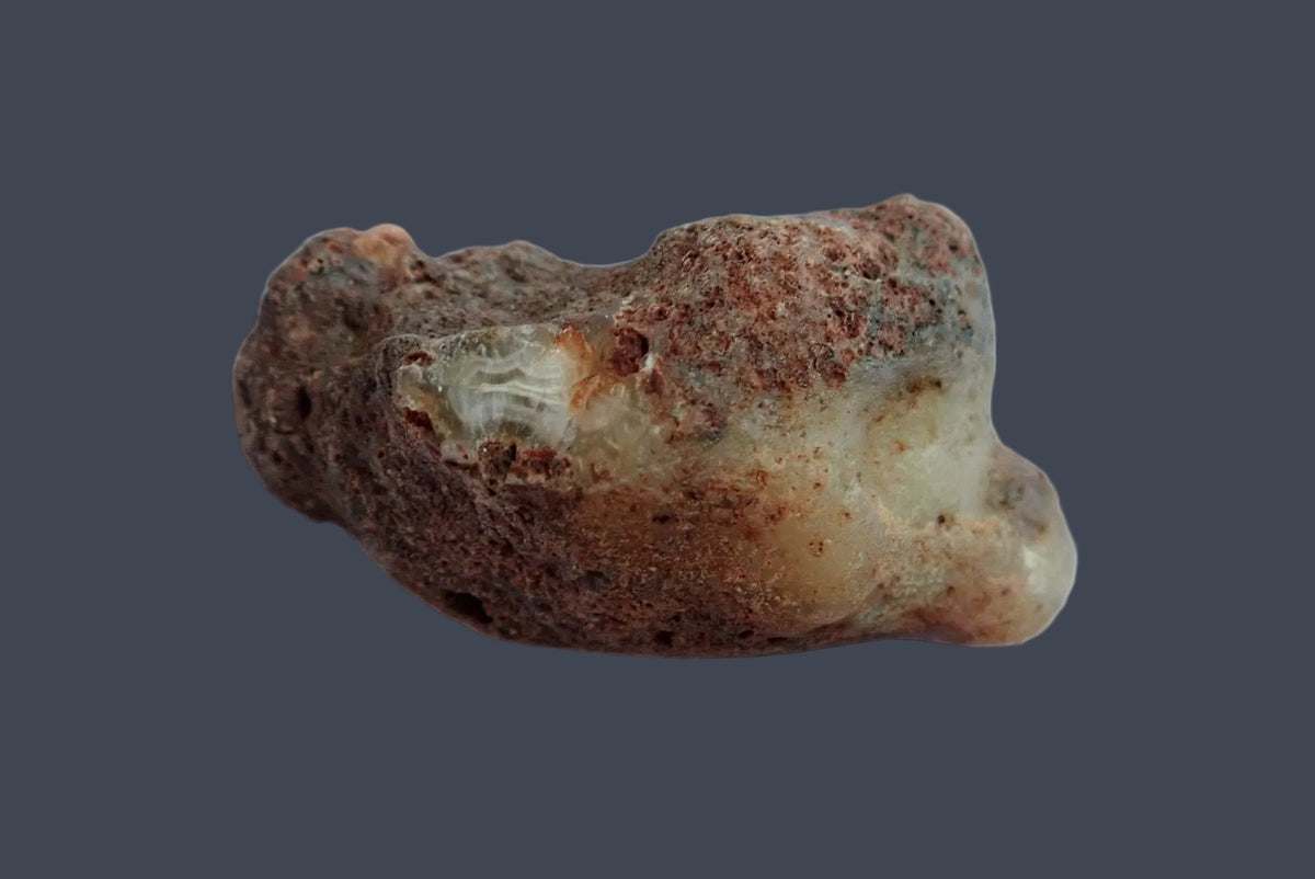 Malawi agate 66 mm, unpolished back with textured brown rind and exposed cream chalcedony, Ngabu, Malawi.