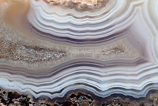Malawi agate 70 mm, detail of shiny calcite in the crystalline centre, surrounded by ghost banding and fine white, grey and pale mauve bands, Ngabu, Malawi.