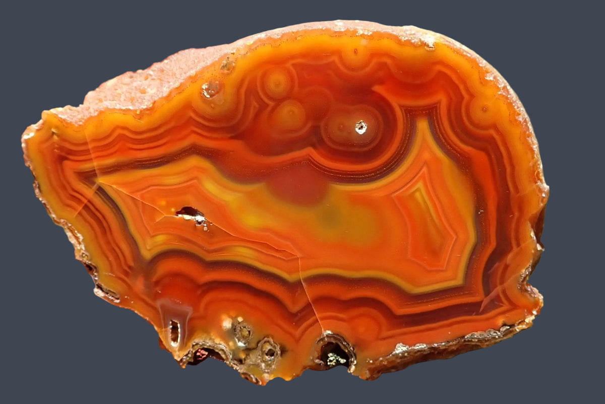 Malawi agate 74 mm – polished face with rounded eyes and angular fortification banding in orange, golden yellow and reddish brown, from Ngabu, Malawi.
