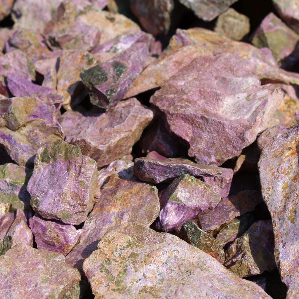 Dry natural stichtite specimen grade large rough in serpentine matrix, Kaapsehoop, South Africa — bulk lot showing natural unpolished surface and pink-purple colour range, dry finish | SKU STICHSPEC