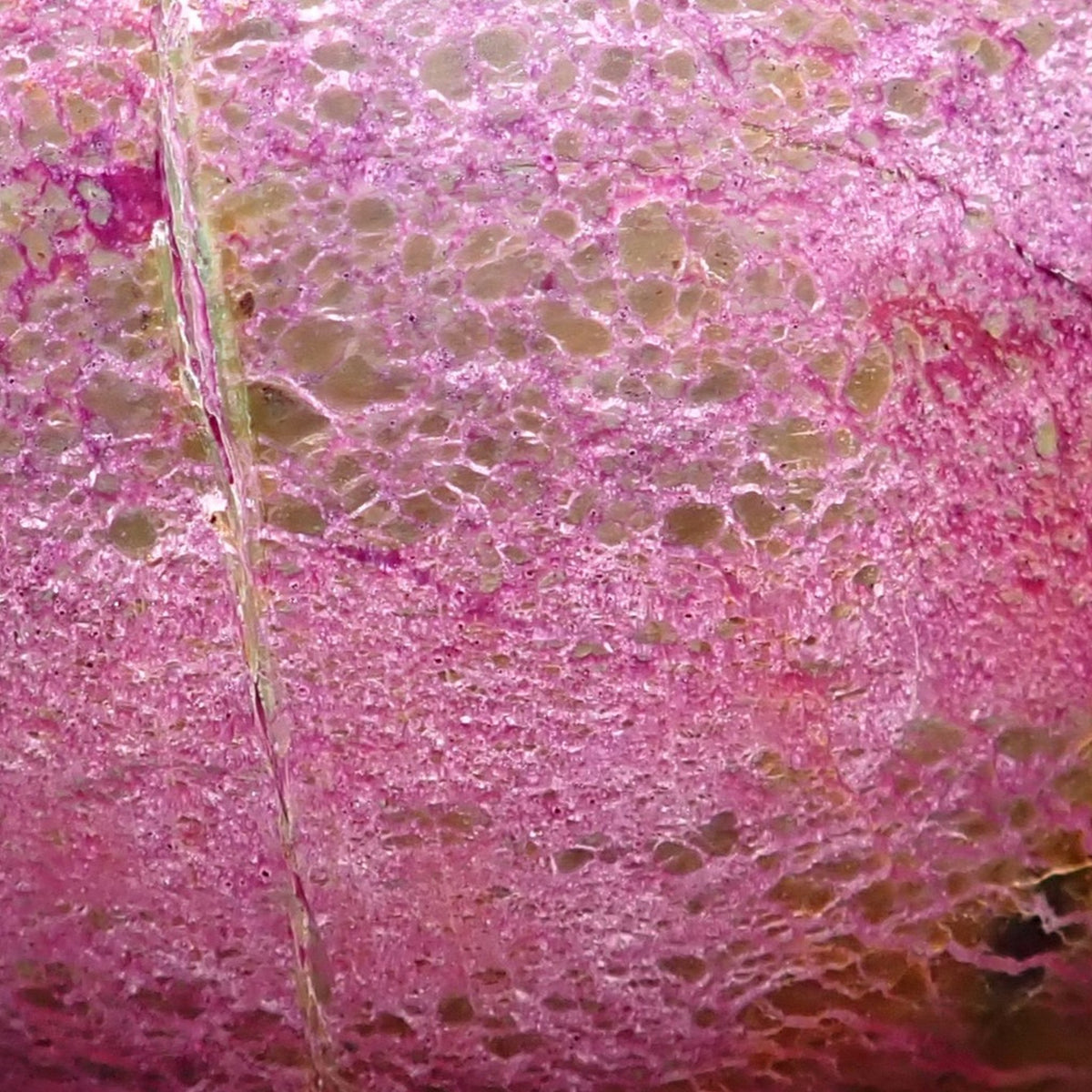 Stichtite with Serpentine close-up showing fine pink-purple intergrowths, small olive patches and pale veining.