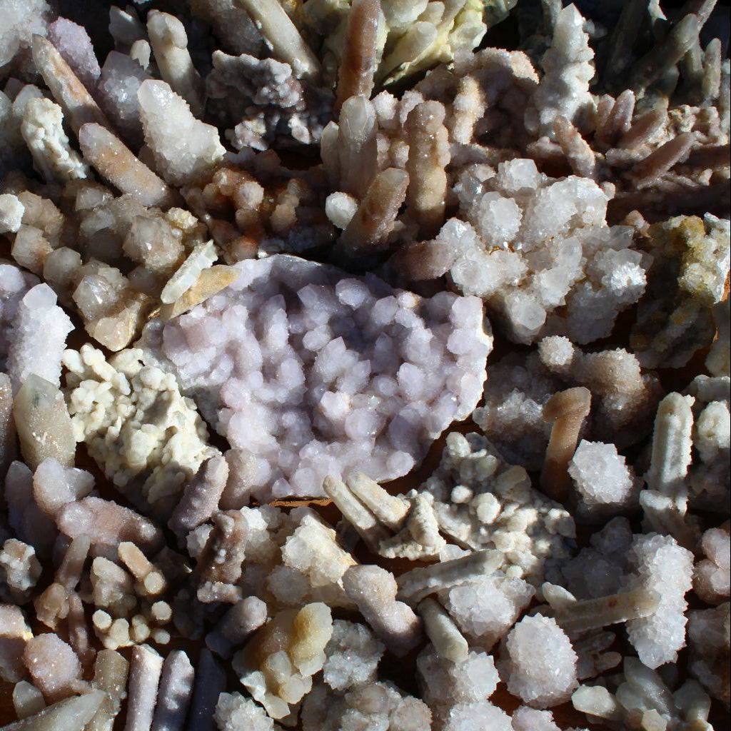 Wholesale white cactus quartz South Africa – overhead view showing broken and healed cactus quartz formations, lilac druzy nodule centrepiece, variable white and cream crystal types | SKU SPQW