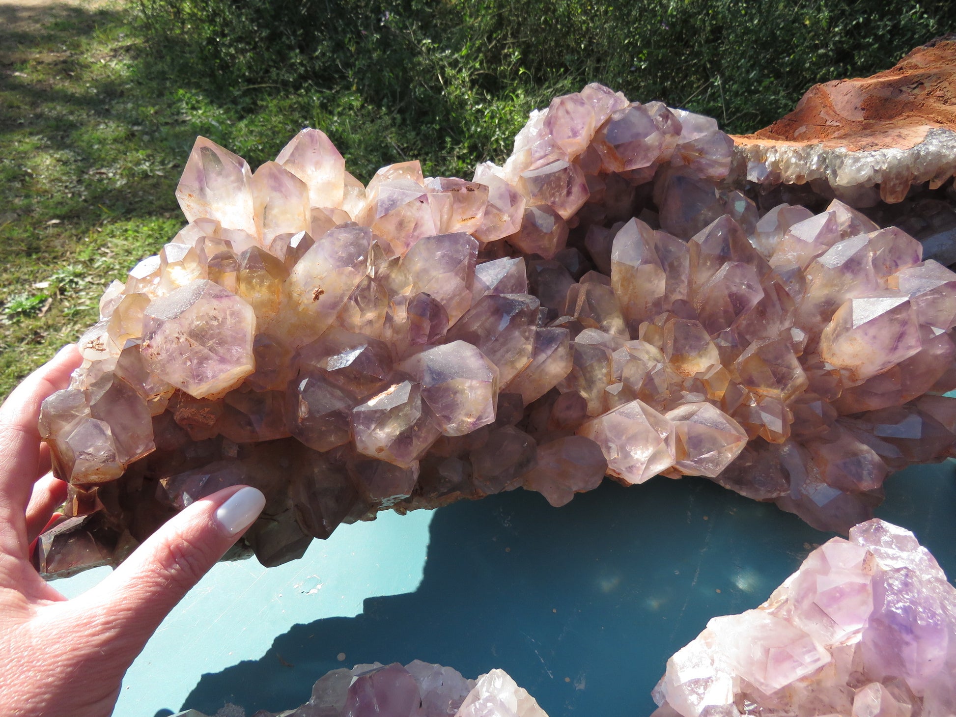 Wholesale Mumbwa amethyst Zambia – in-hand extra-large cluster showing oversized translucent violet points, pale lavender coloration, iron oxide inclusions, XL formation type | SKU MUMkg