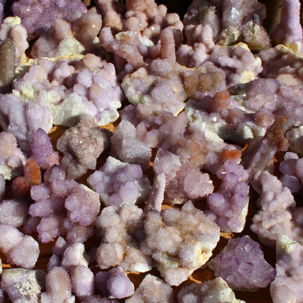 Wholesale spirit quartz South Africa – close-up of individual cactus quartz clusters on matrix, druzy crystal coverage, lilac-purple tones, white matrix base | SKU SPQA