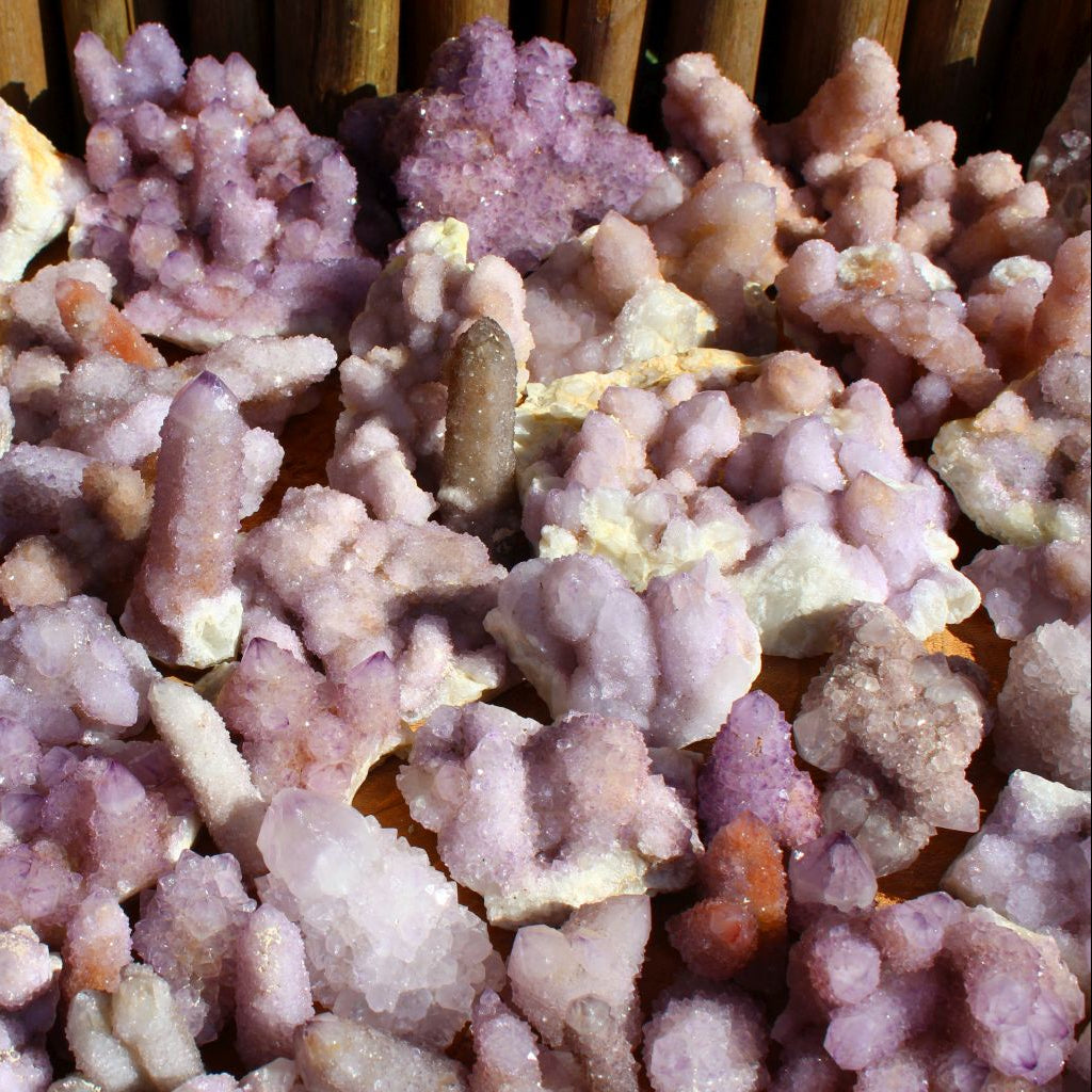 Wholesale spirit quartz South Africa – mixed cactus quartz cluster specimens showing druzy coverage and matrix attachment, variable purple tones | SKU SPQA