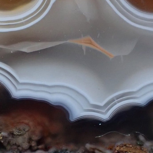 close-up of a Malawi agate from Ngabu region with ghost banding and a small orange floater