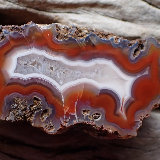 Close-up of a Malawi agate with red and purple banding around a crystalline centre