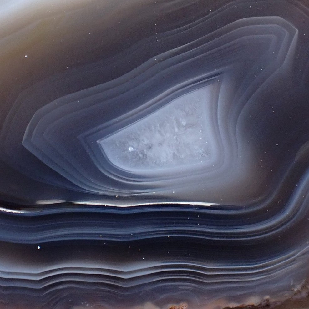Detail of face, natural hand-polished Malawi agate 60 mm – layered ghost banding, angular inner band form, pale crystalline centre, deep blue-grey palette, Ngabu, Malawi | SKU 000394