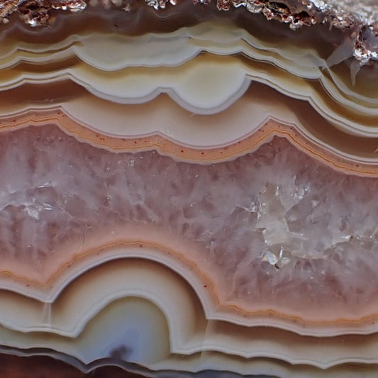 Close up of candy agate ghost with ghost fortification banding in unusual pastel colours ranging in browns, rust, salmon, peach and pink