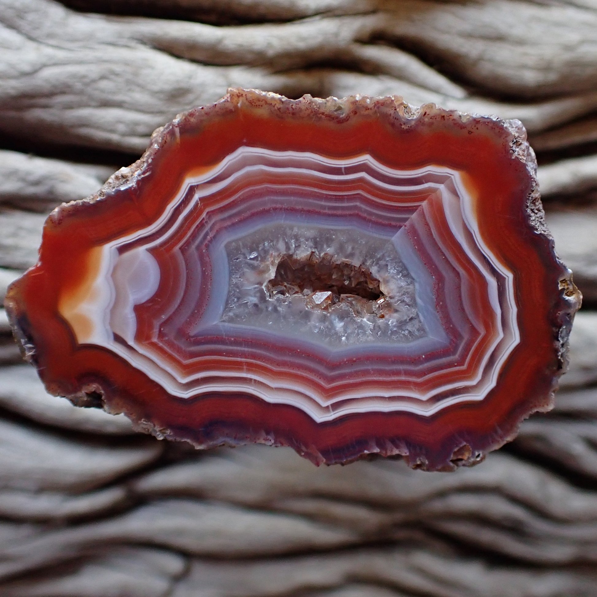 Lovely red white and purple banded Malawi agate with a crystalline centre and lovely ghost banding