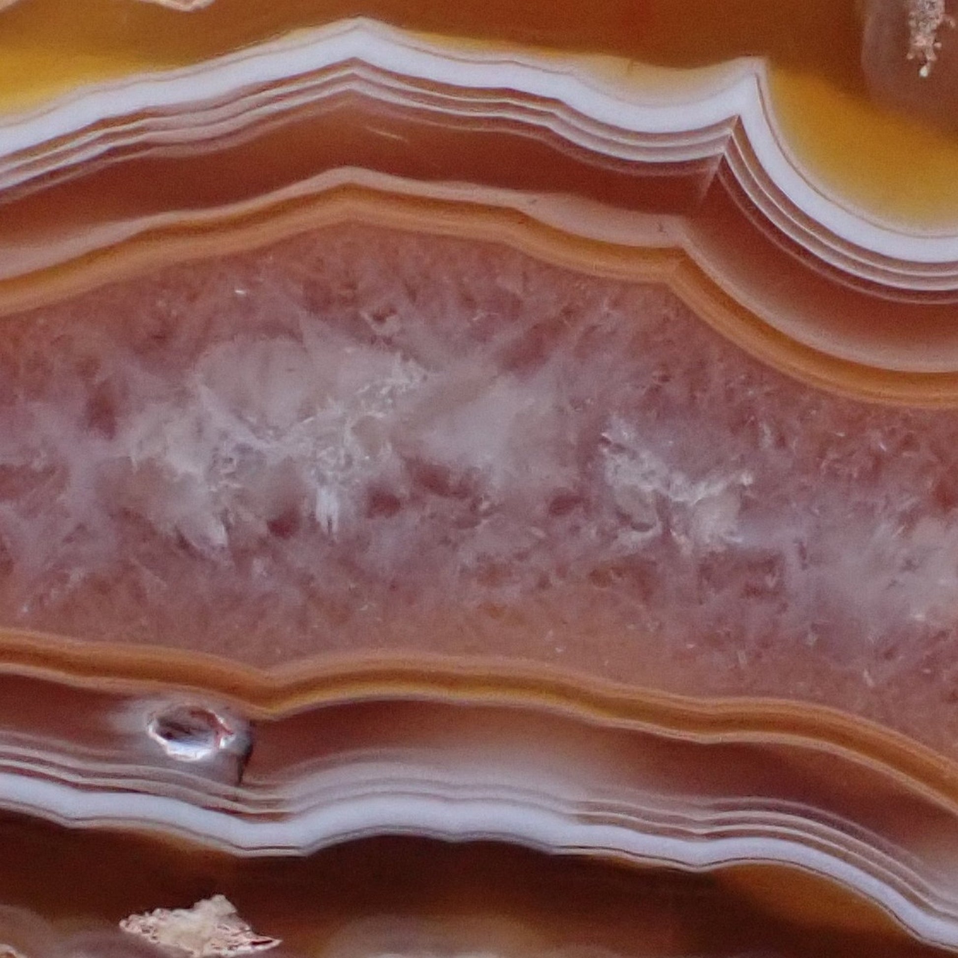Polished Malawi agate 52 mm – face detail, scalloped band edges, ghost banding in chalcedony layers, smooth crystalline centre | SKU 000495