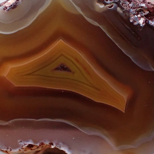 Natural hand-polished Malawi agate 48 mm – face detail, angular tent-peaked centre, scalloped banding, ghost banding | SKU 000497