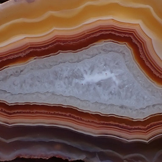 Crystalline centre of a Malawi candy agate ringed in red and orange bands