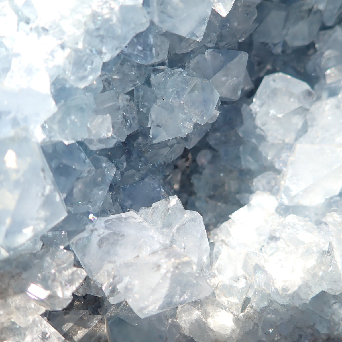 Celestite from Madagascar, detailed view of translucent pale blue crystals with broad faces inside the geode.