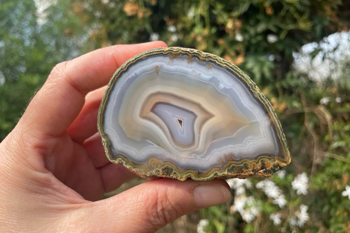 Ghost Mountain agate 80 mm – in-hand size reference, half nodule form, concentric banding and drusy vug, South Africa