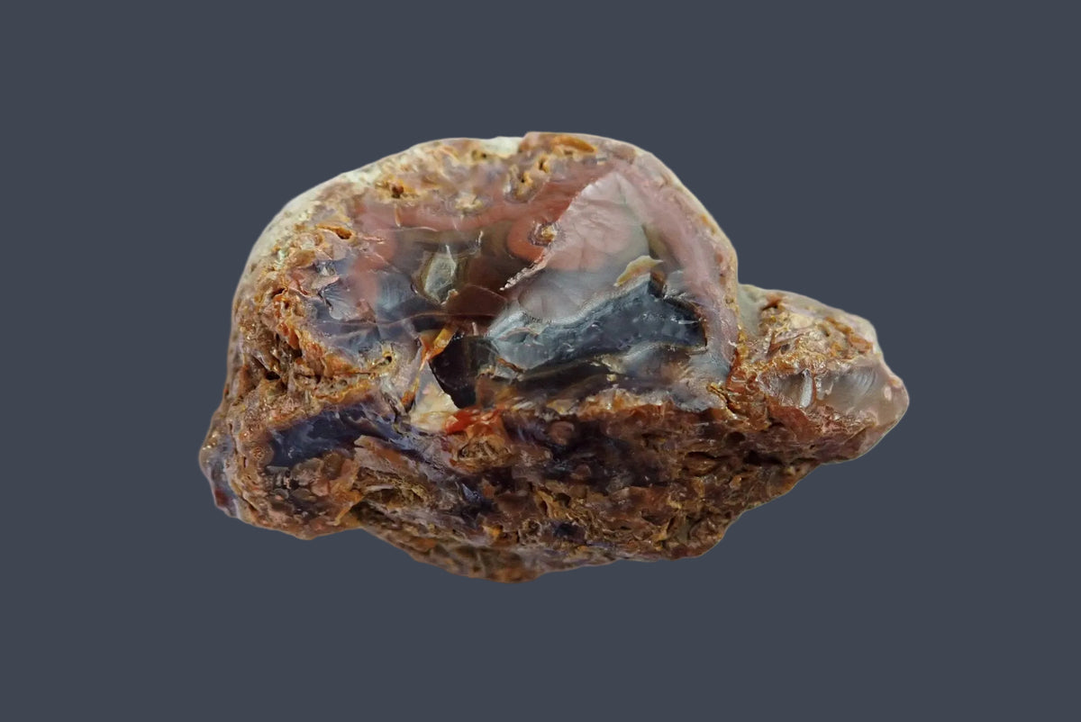 Lilangabi agate 68 mm – back view showing rough natural rind and exposed grey-brown stone, Lebombo Mountains.