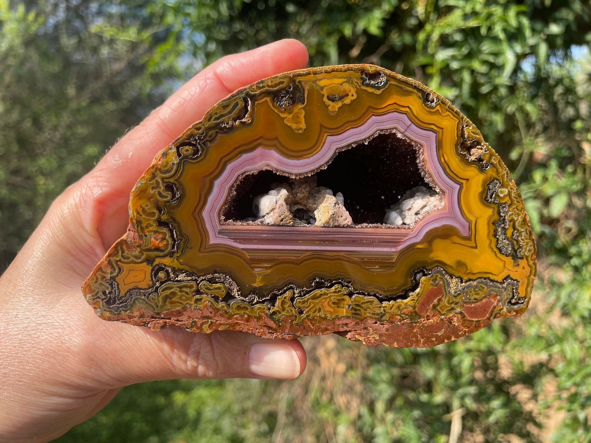 Lilangabi agate 130 mm – in-hand size reference, purple chalcedony band and druzy vug visible, Eswatini | SKU LIL00009