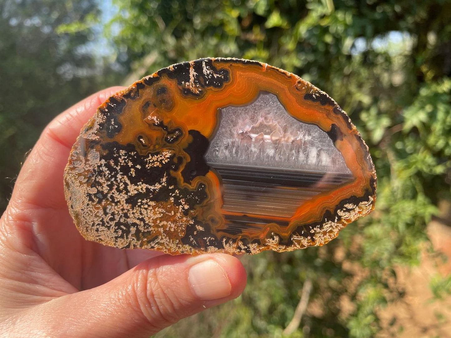 Lilangabi agate 90mm – in-hand, chalcedony centre and waterline section visible | SKU LIL00017