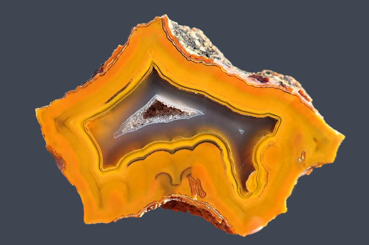 Lilangabi agate 88mm – main view, fortification banding, chalcedony centre, scalloped banding, amber-gold palette | SKU LIL00021