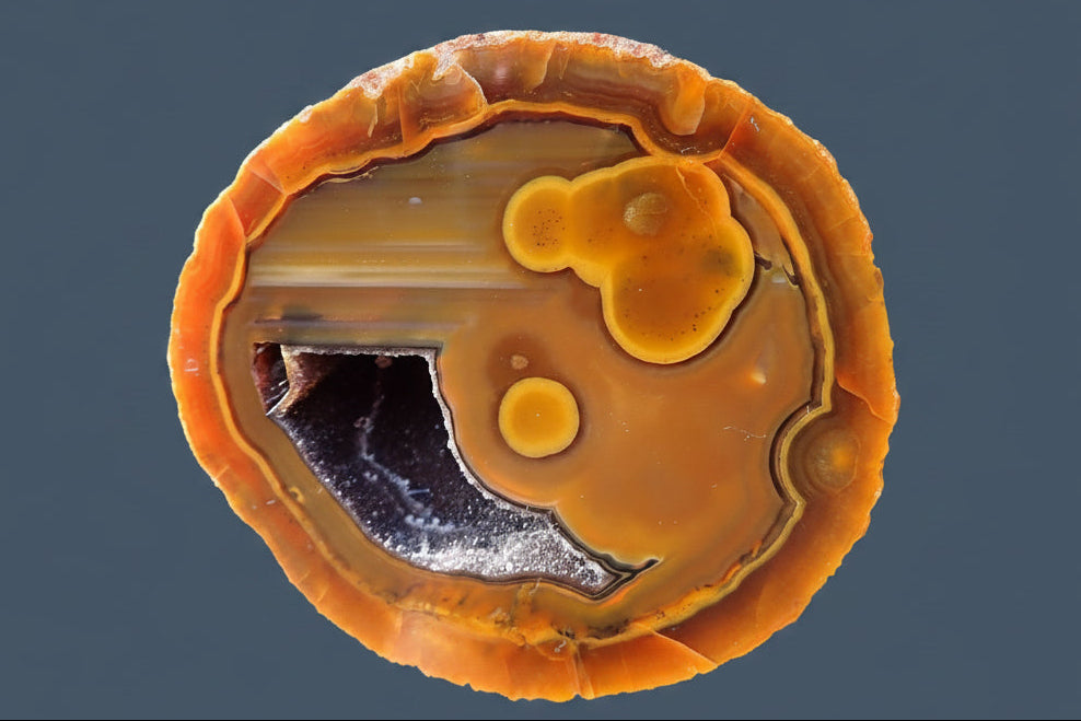  Lilangabi agate 66 mm – face view, agate eyes, waterlines, goethite needles in vug, fiery amber-orange palette