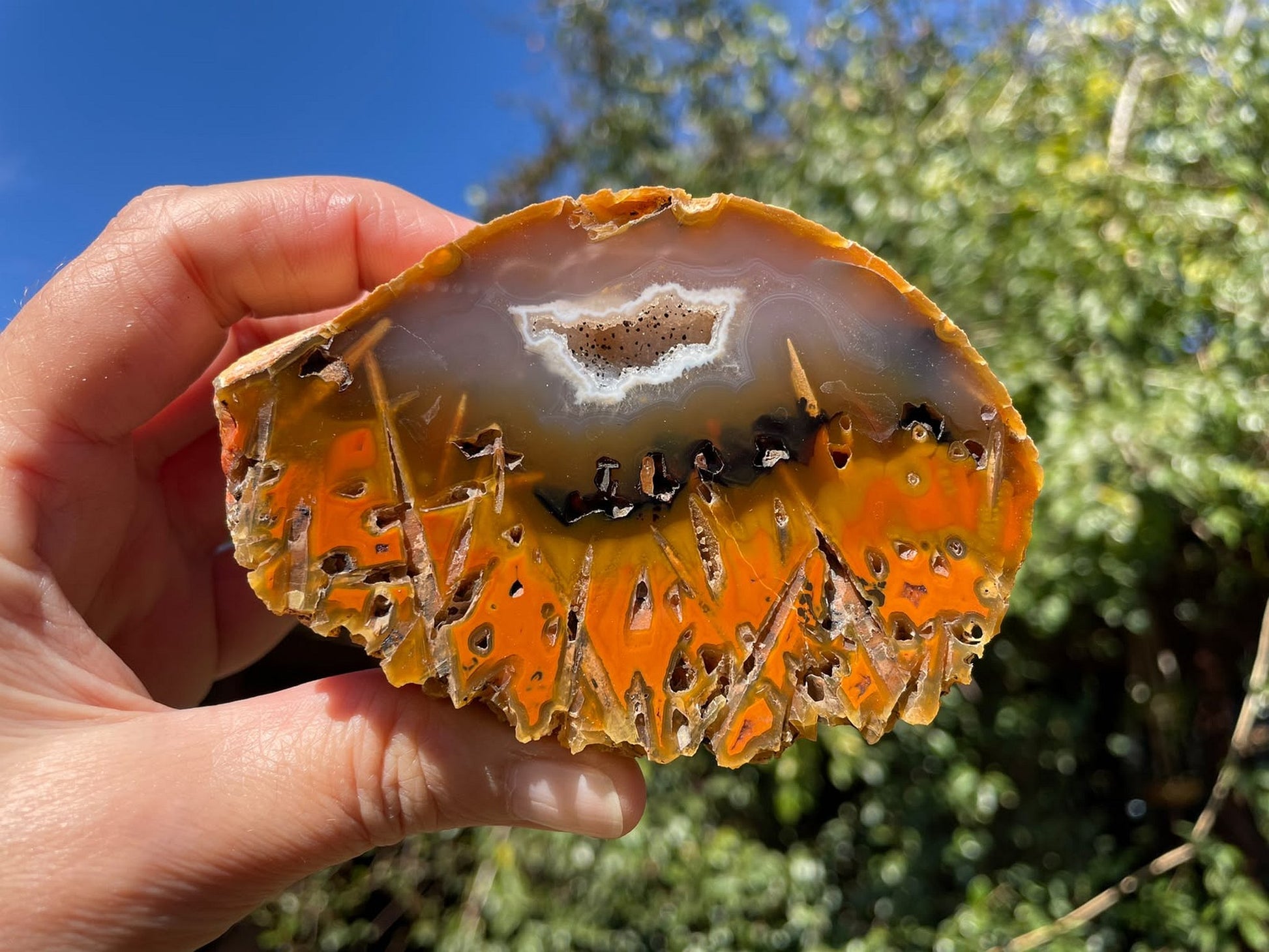 Lilangabi agate 96 mm – in-hand size reference, stick agate, chromatism, natural sunlight