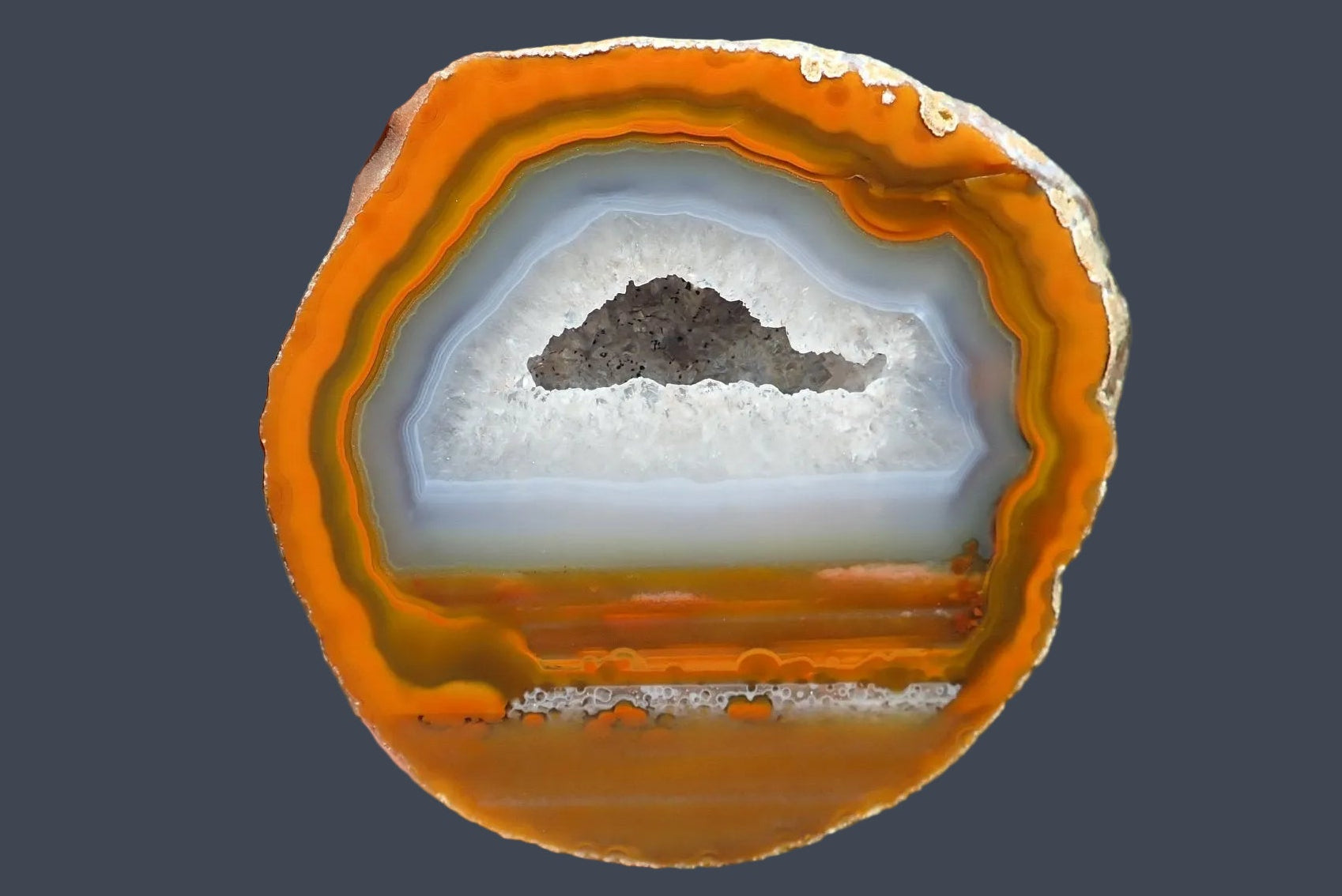 Lilangabi agate 84 mm – front face, large drusy vug with goethite specks, smooth orange and amber banding, Eswatini