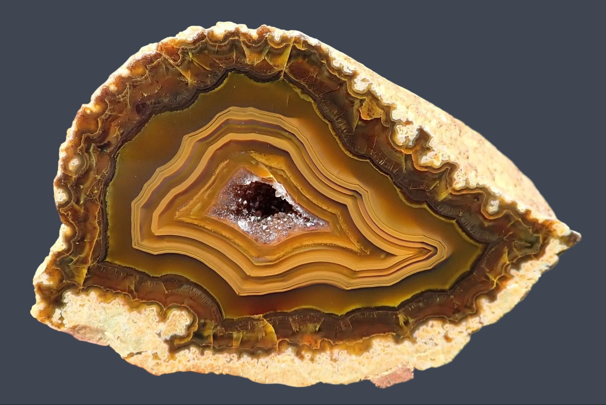 Lilangabi agate 75 mm – front view, smooth concentric oval banding, amethyst drusy vug, amber and golden-ochre palette