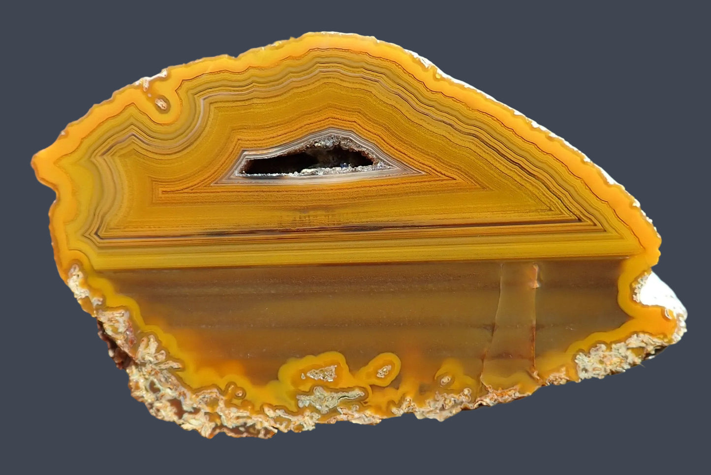 Lilangabi agate 86 mm – front face, angular fortification banding and drusy vug, deep amber and burnt orange