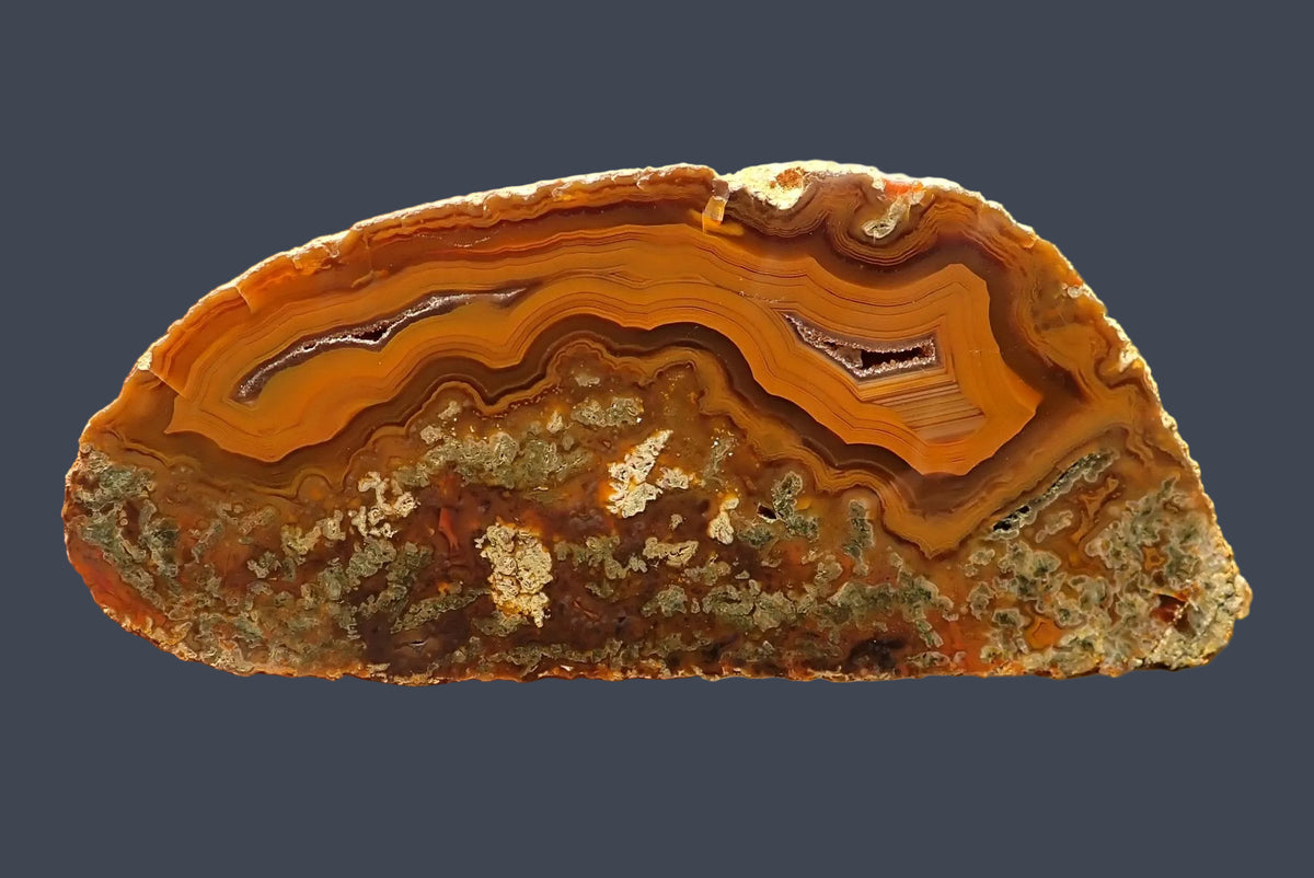 Lilangabi agate 102 mm – full face, scalloped banding in deep amber and burnt orange, twin drusy vugs, Lebombo Mountains