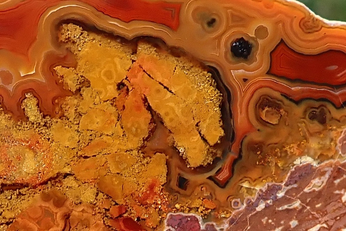 Close-up of red, orange and amber banding with natural inclusions in Lilangabi agate from the Lebombo Mountains
