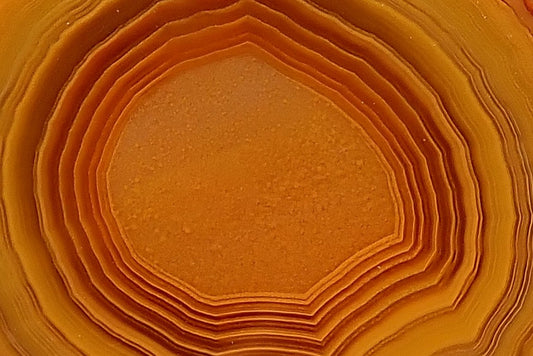 Close-up of amber and burnt-orange chromatography in Lilangabi agate LIL00091