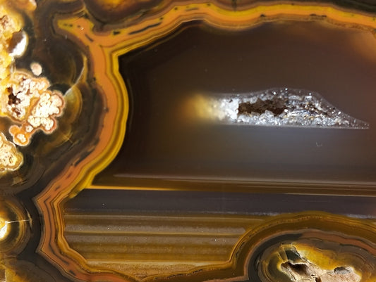 Lilangabi agate 64mm – close-up, waterlines and scalloped band edges, amber-sard tones | SKU LIL00015