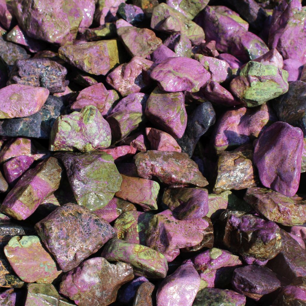 Wet natural stichtite rough specimens in serpentine matrix, Kaapsehoop, South Africa — bulk lot showing pink to purple colour range, wet finish | SKU STICHRsml