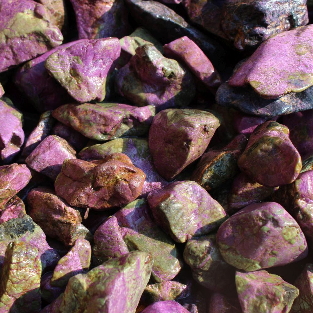 Wet natural stichtite rough specimens in serpentine matrix, Kaapsehoop, South Africa — bulk lot showing pink to purple colour range, wet finish | SKU STICHRsml
