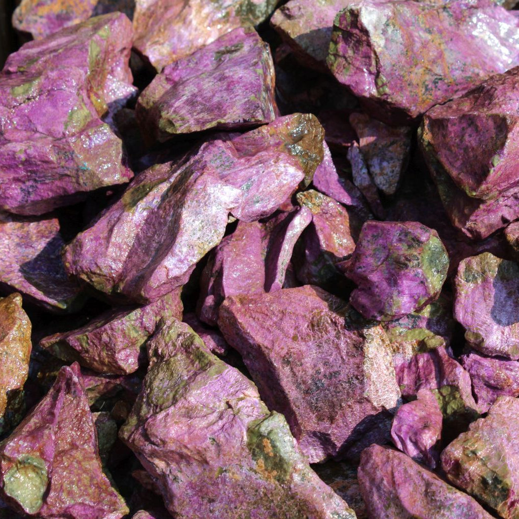 Wet natural stichtite specimen grade large rough in serpentine matrix, Kaapsehoop, South Africa — bulk lot showing vivid pink-purple colour range, wet finish | SKU STICHSPEC