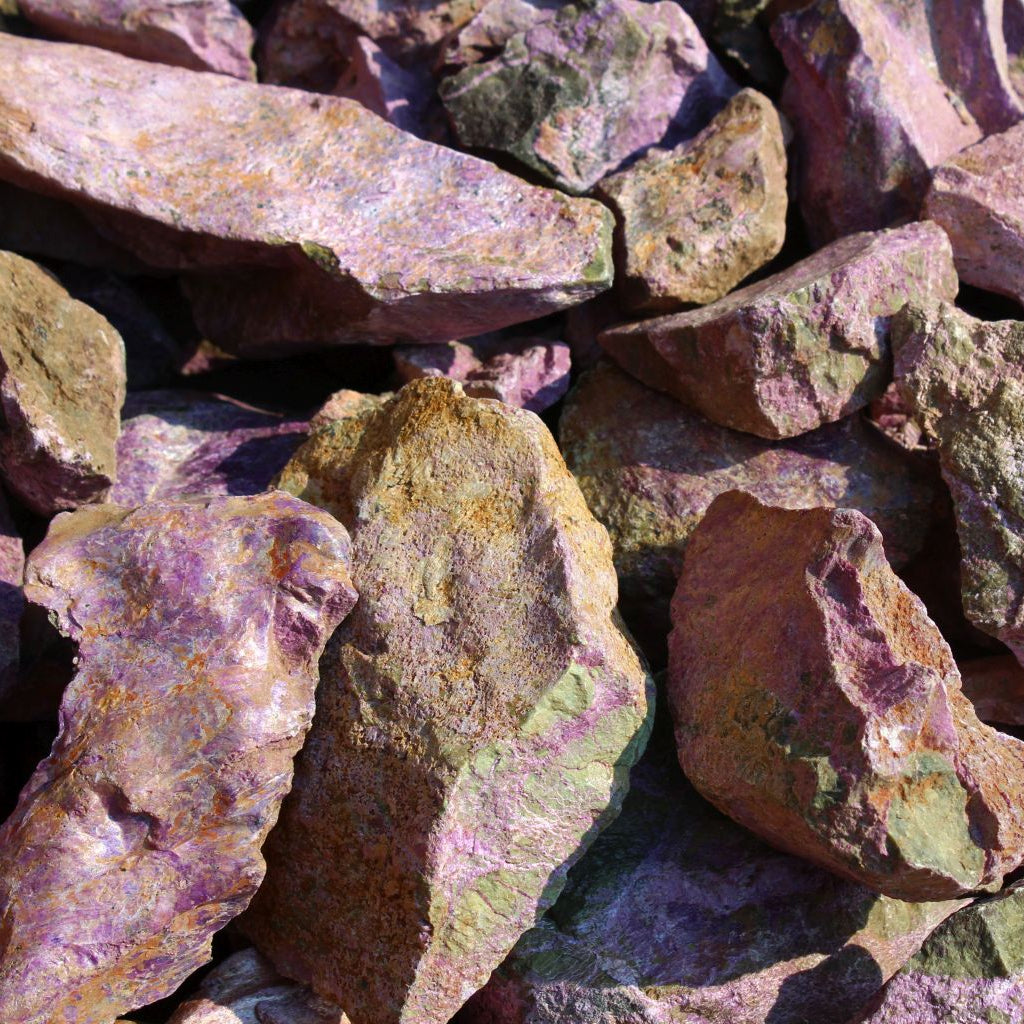 Dry natural stichtite specimen grade large rough in serpentine matrix, Kaapsehoop, South Africa — bulk lot showing natural unpolished surface and pink-purple colour range, dry finish | SKU STICHSPEC