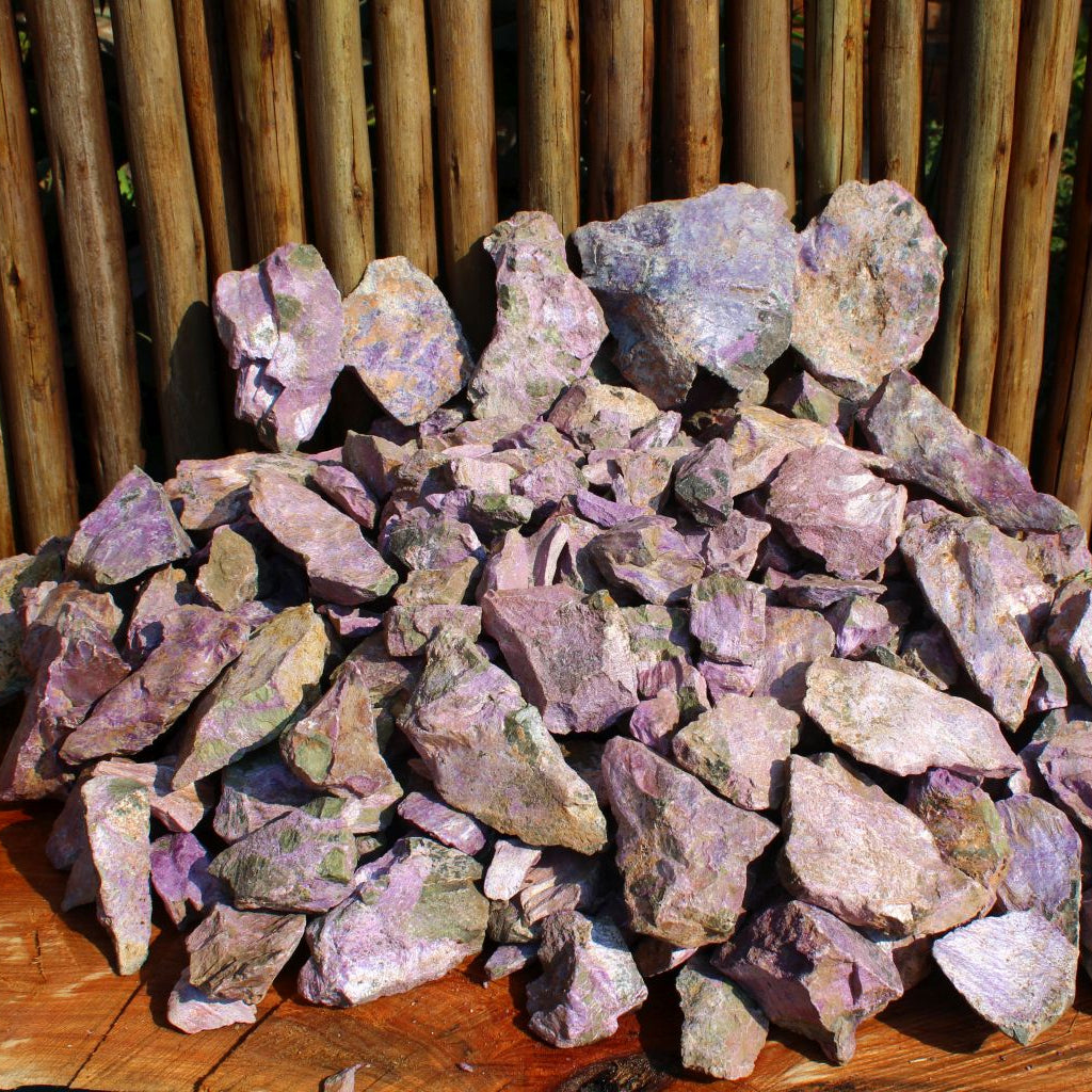 Dry natural stichtite specimen grade large rough in serpentine matrix, Kaapsehoop, South Africa — bulk lot showing natural unpolished surface and pink-purple colour range, dry finish | SKU STICHSPEC