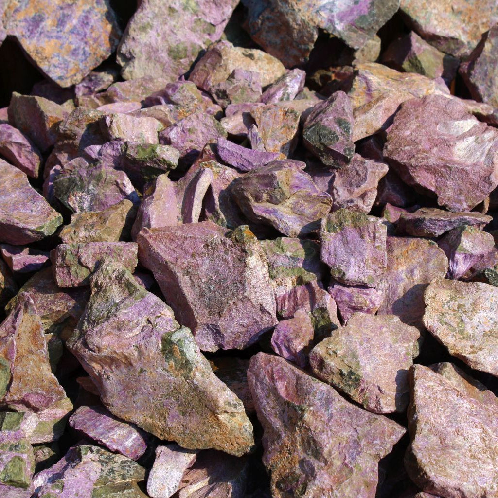 Dry natural stichtite specimen grade large rough in serpentine matrix, Kaapsehoop, South Africa — bulk lot showing natural unpolished surface and pink-purple colour range, dry finish | SKU STICHSPEC
