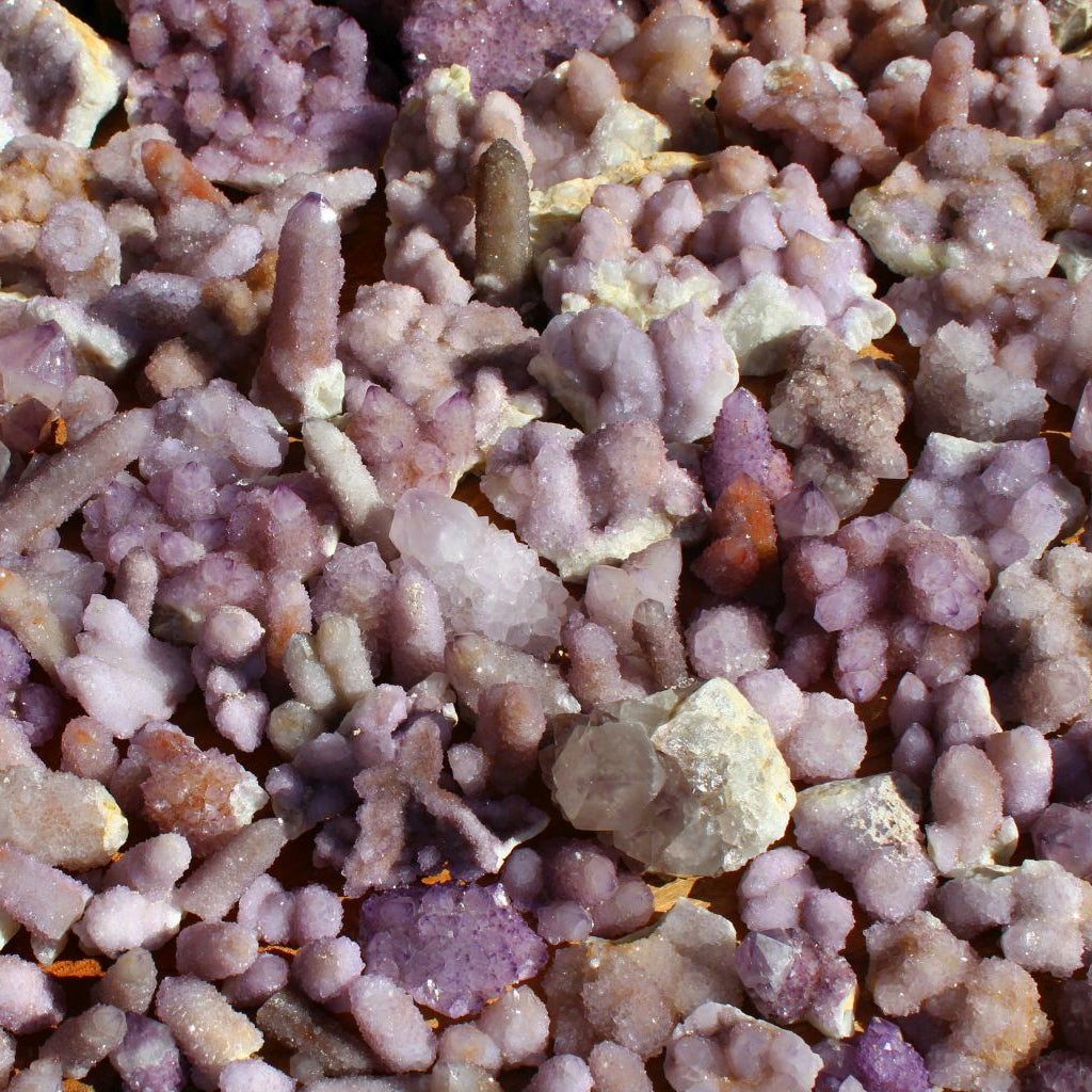 Wholesale spirit quartz South Africa – bulk lot spread showing variable cactus quartz formations, mixed lilac and purple specimens, natural cleaned condition | SKU SPQA