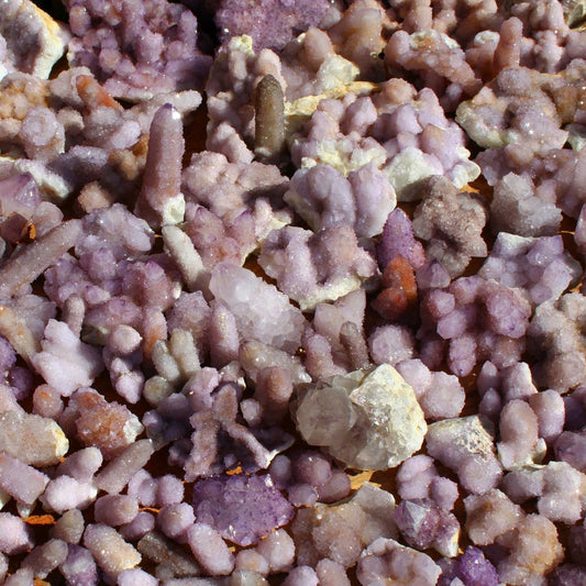 Wholesale spirit quartz South Africa – bulk lot spread showing variable cactus quartz formations, mixed lilac and purple specimens, natural cleaned condition | SKU SPQA