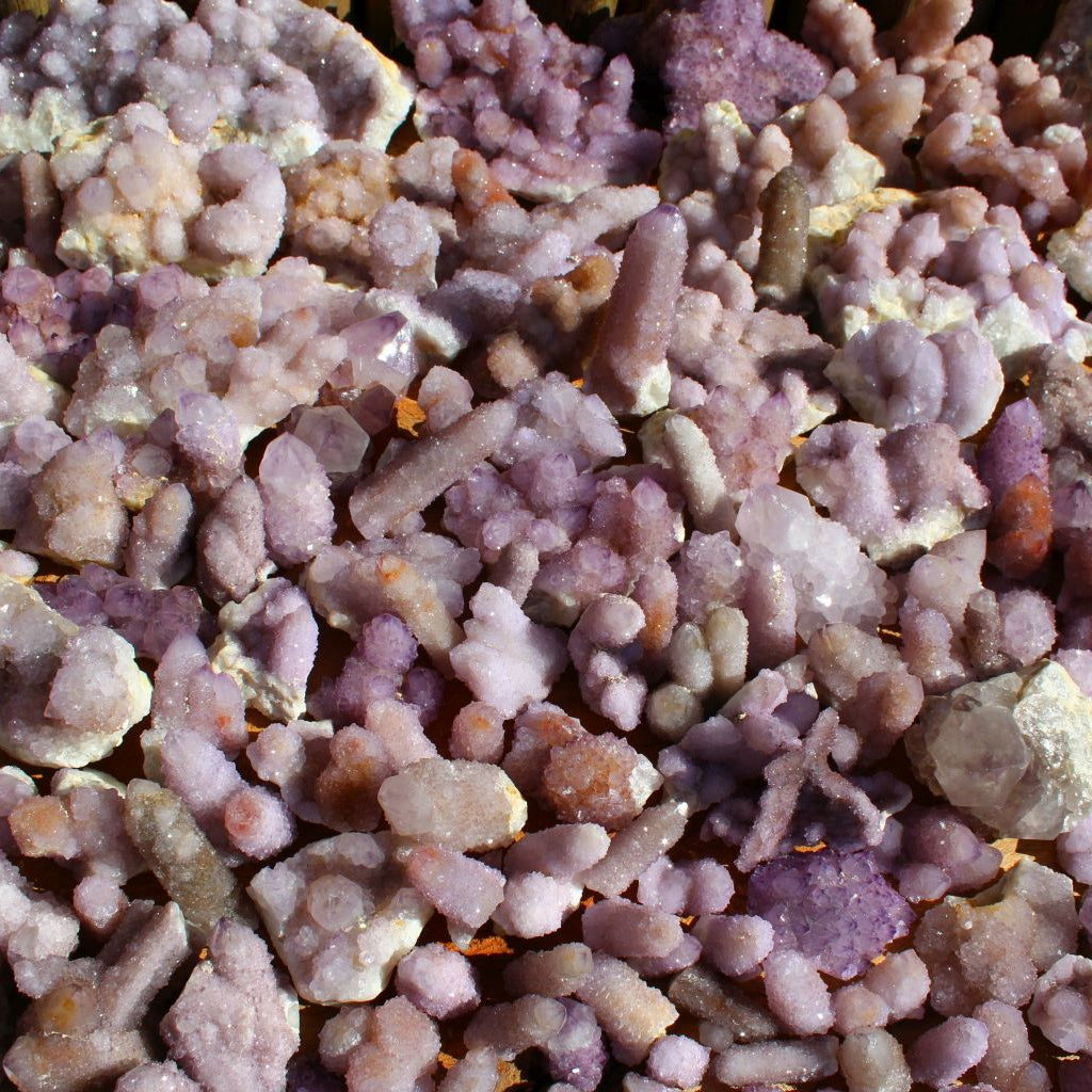 Wholesale spirit quartz South Africa – close-up of multiple cactus quartz clusters on matrix, compact druzy formations, lilac-purple colour range | SKU SPQA