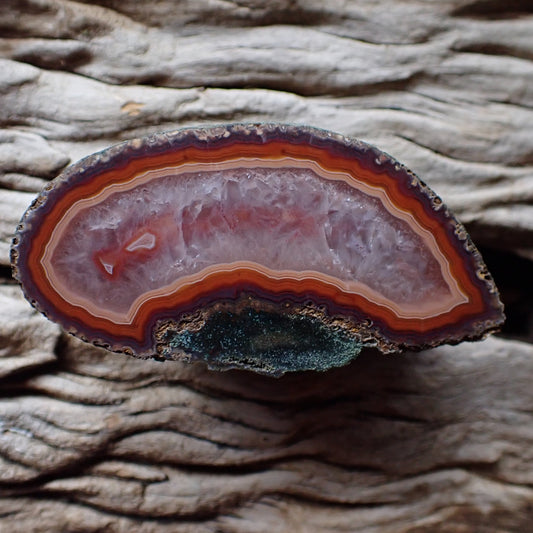 Polished Malawi agate from Ngabu region with lovely salmon and red banding with a crystalline centre and two small floaters