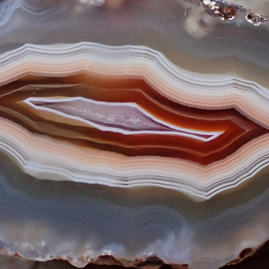 Close-up of a Malawi candy agate crystalline centre ringed in red and white