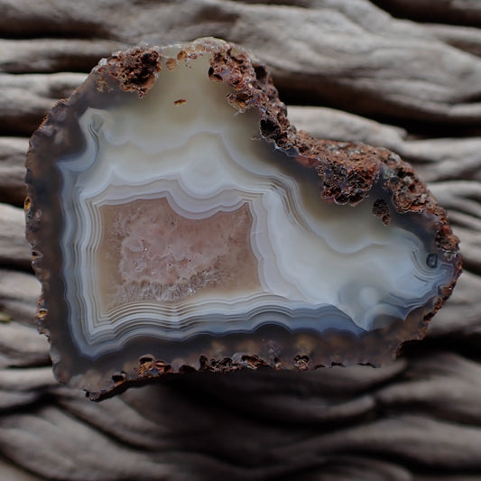 Polished Malawi agate from the Ngabu region with mouted white and peach colouration around a pretty crystalline centre, ringed with ghost banding and eye