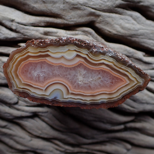 Polished Malawi agate from the Ngabu region with ghost fortification banding in unusual pastel colours ranging in browns, rust, salmon, peach and pink