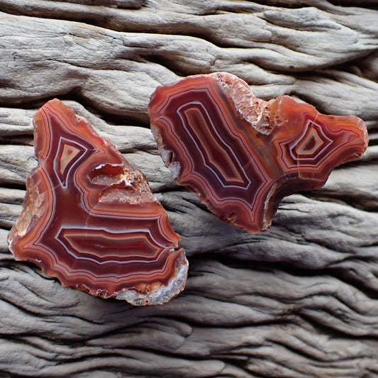 Polished matching Malawi agate pair from the Ngabu region with double chambers and fortification banding in reds orange and peach