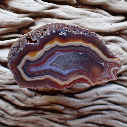 Stunning Malawi agate with eye and flow channels and crystalline centre surrounded by blue and red bands