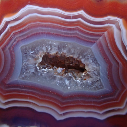 close-up of the drusy or crystalline centre in a brightly red and white banded Malawi candy agate